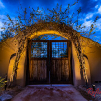 Lighting to accent vine work on gated arch