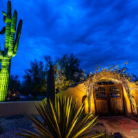 Highlighting gated entryway and desert landscape with outdoor lighting