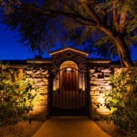 gate to front courtyard lit up at night