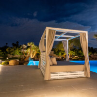 inground pool cabana at night
